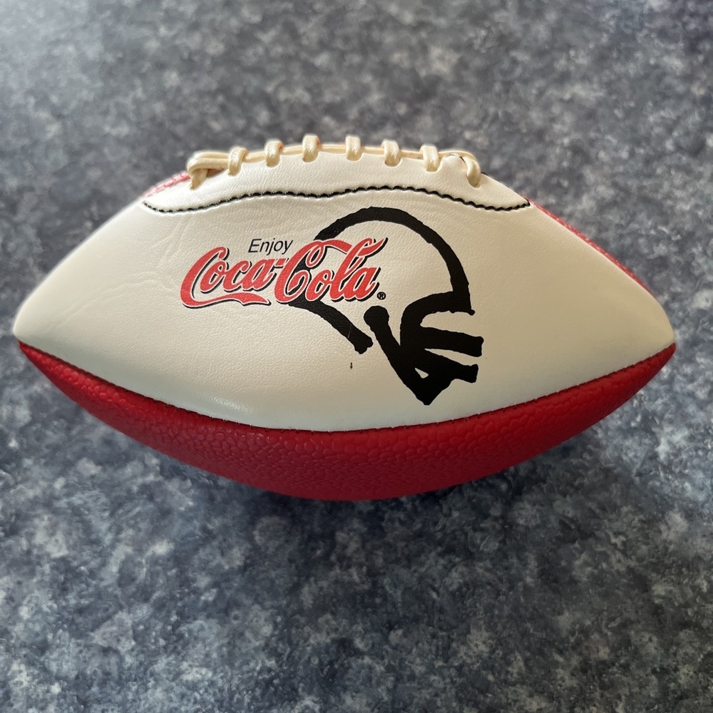 2 Collectible Coca Cola Mini Footballs. (1-leather, 1- foam) approx. 7 inches